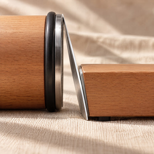 Close side view: the flat diamond disc of the roller touches the edge of a knife held on the angle block